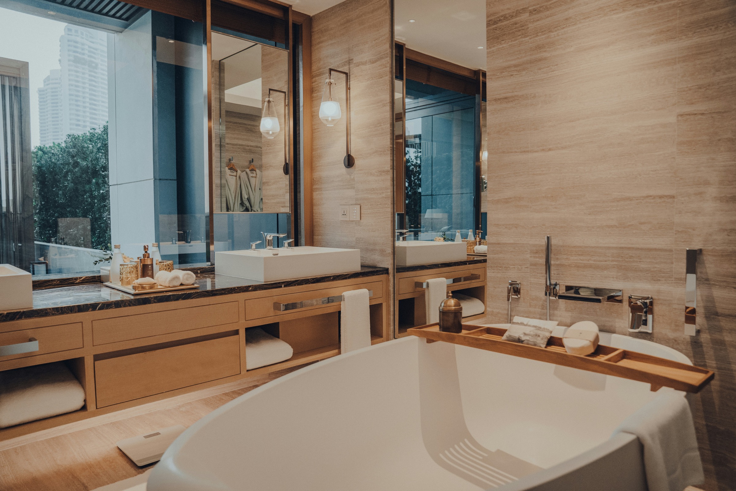Premium bathroom with bathtub, vanity mirrors and warm timber details