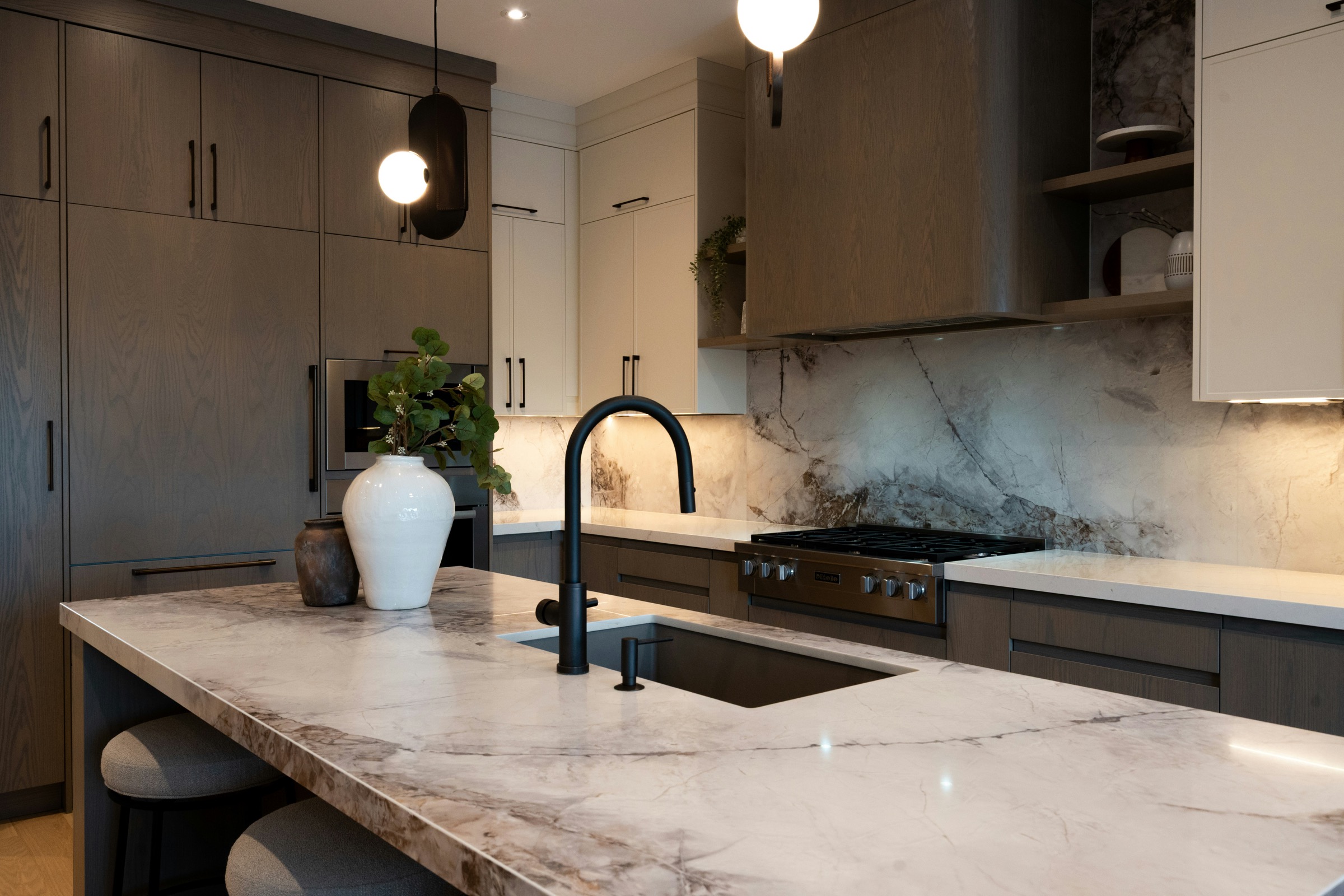 Luxury kitchen with marble island and matte black faucet