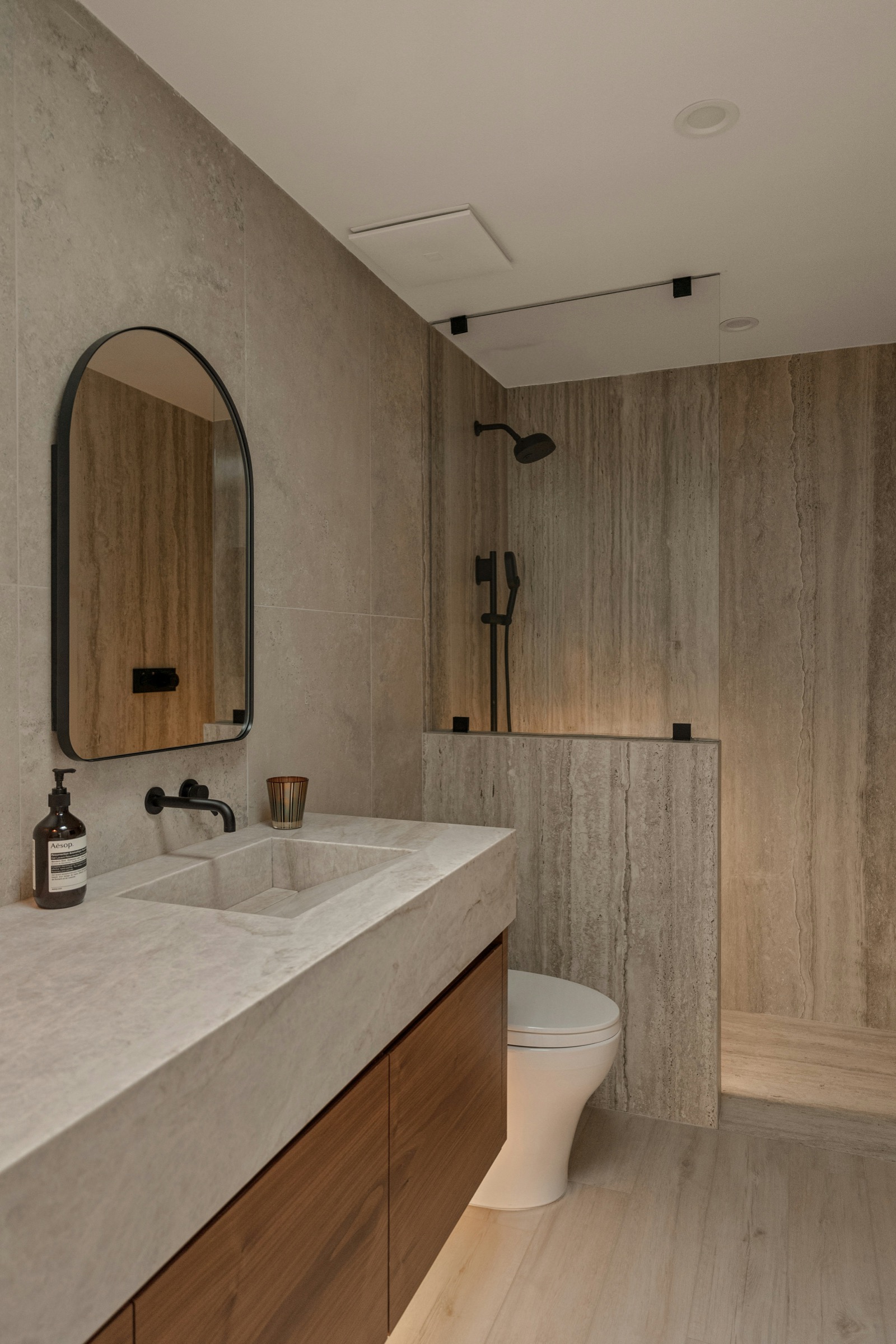 Premium bathroom with stone vanity, mirror and walk-in shower