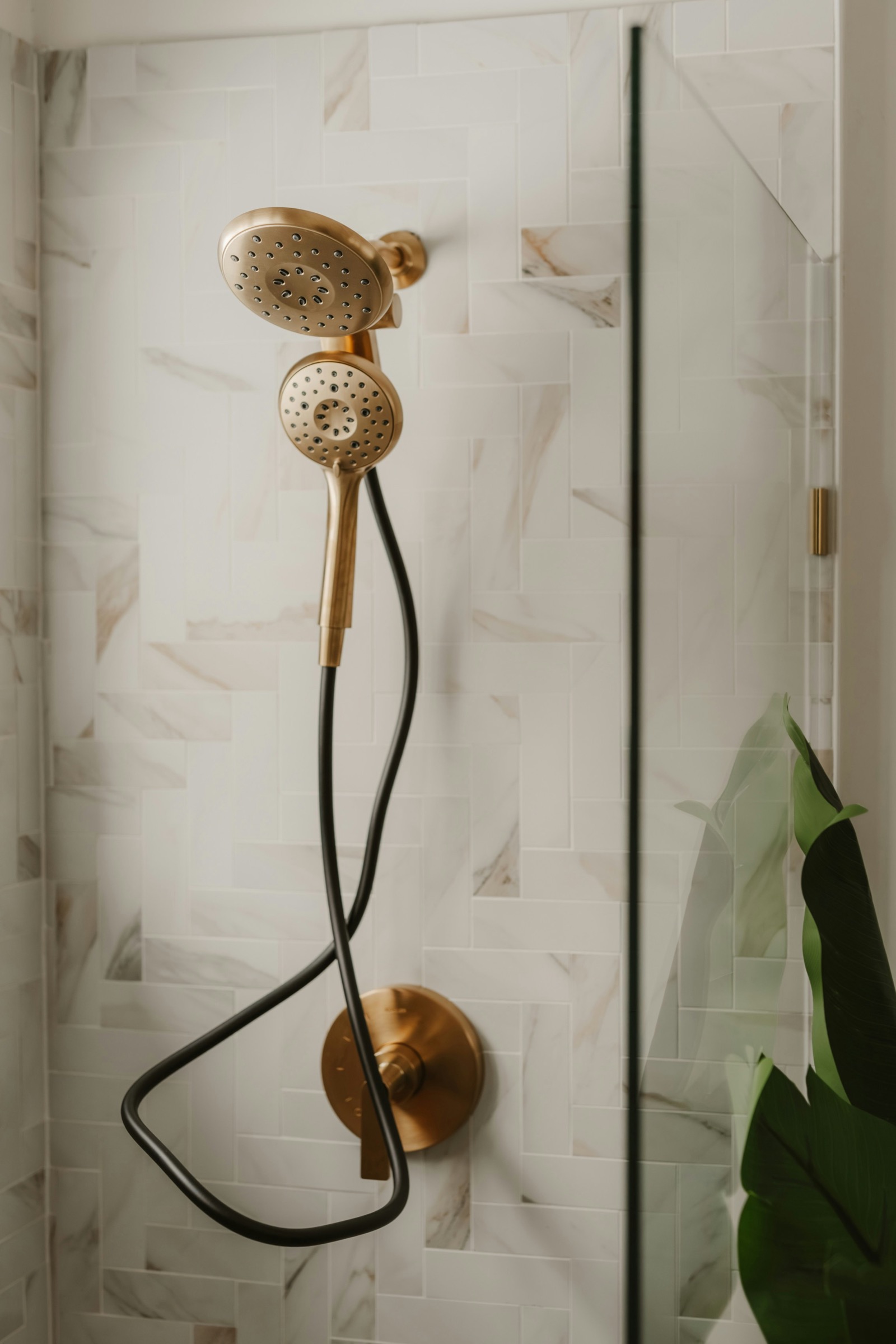 Brass shower system in a bright modern bathroom